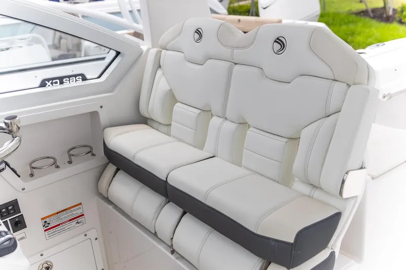 Slide: The Image of 2026 Edgewater 262 CX boat interior with luxurious white seating and cup holders. - 3