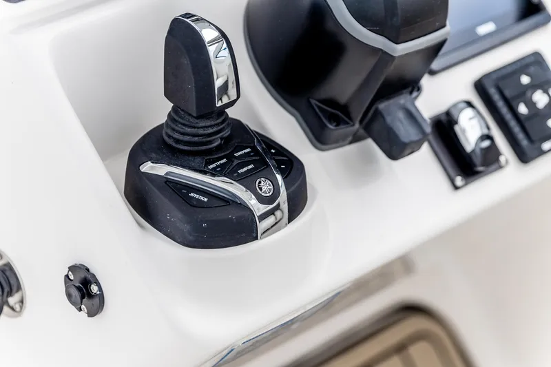 Slide: The Image of 2026 Edgewater 262 CX boat control panel with joystick and buttons. - 33