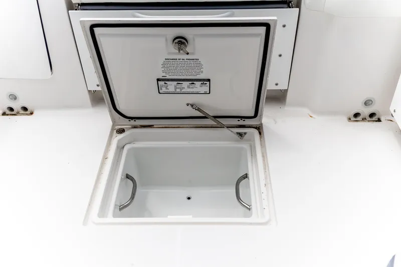 Slide: The Image of Open storage compartment on 2026 Edgewater 262 CX boat deck. - 36