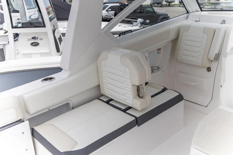 Slide: The Image of Luxurious seating on 2026 Edgewater 262 CX boat, featuring modern white and gray upholstery. - 4