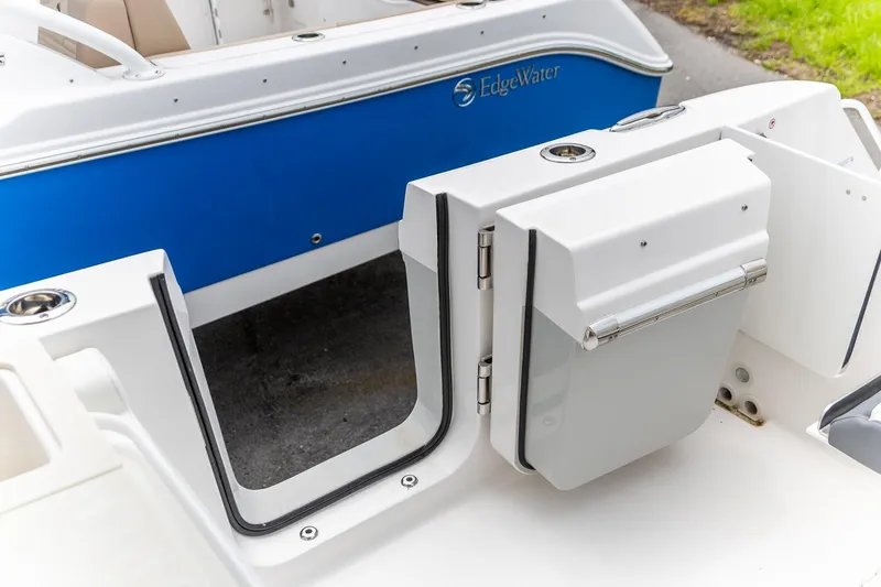 Slide: The Image of 2026 Edgewater 262 CX boat with open transom door, blue and white design. - 6