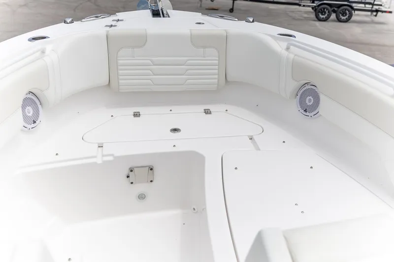 Slide: The Image of 2026 Edgewater 262 CX boat interior with white seating and speakers. - 8