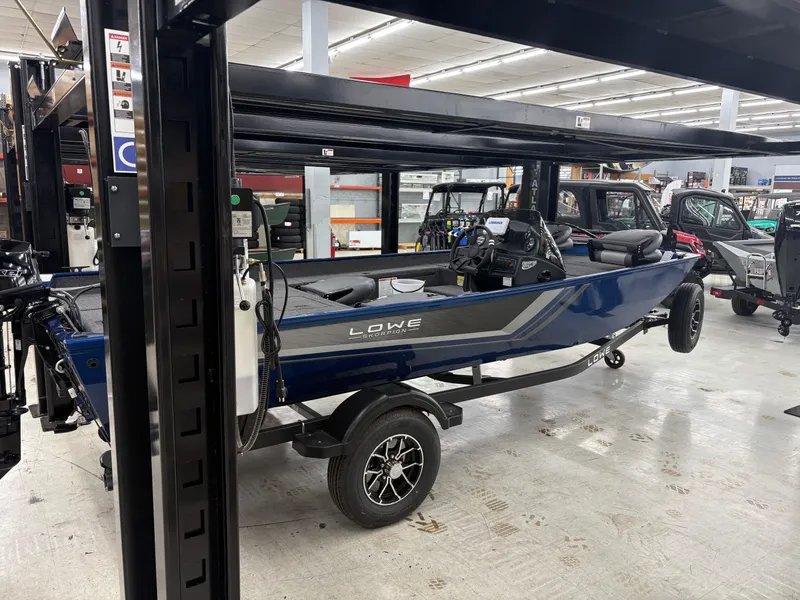 Slide: The Image of 2025 Lowe Skorpion 17 boat displayed indoors on a trailer. - 3
