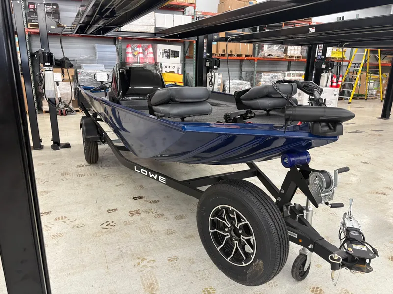Slide: The Image of 2025 Lowe Skorpion 17 boat on trailer in warehouse setting. - 4
