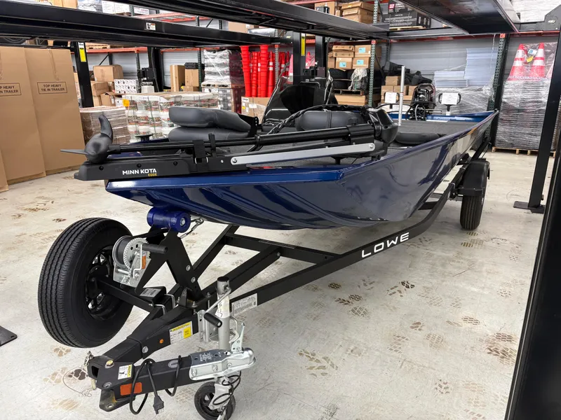 Slide: The Image of 2025 Lowe Skorpion 17 boat on trailer in warehouse setting. - 6