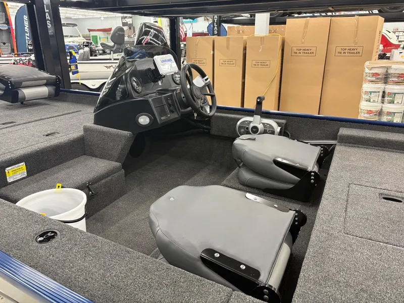 Slide: The Image of Interior of a 2025 Lowe Skorpion 17 boat with steering console and seating. - 7