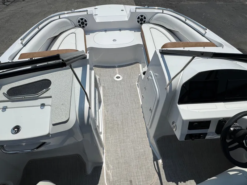 Slide: The Image of 2025 Stingray 201 DC boat interior with seating, dashboard, and speakers. - 11