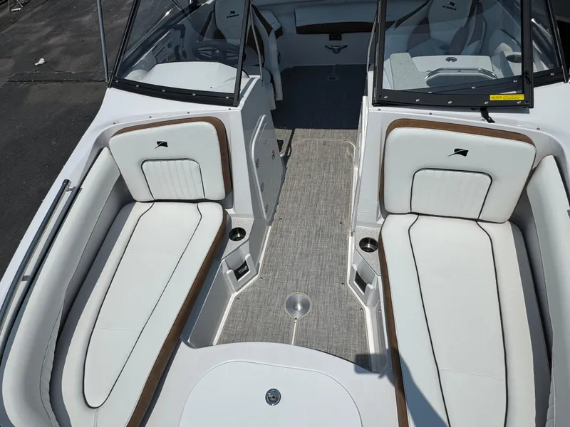 Slide: The Image of 2025 Stingray 201 DC boat interior with white seating and gray flooring. - 14