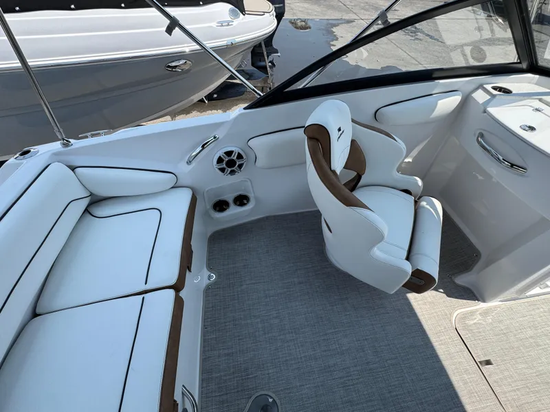 Slide: The Image of 2025 Stingray 201 DC boat interior with white and brown seating, modern design. - 19