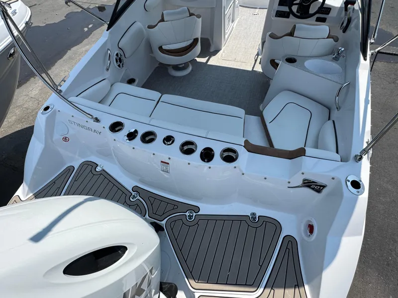 Slide: The Image of 2025 Stingray 201 DC boat interior with white seating and modern design. - 2