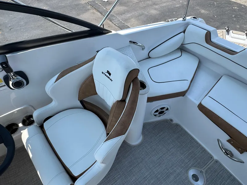 Slide: The Image of 2025 Stingray 201 DC boat interior with white and brown seating, modern design. - 4
