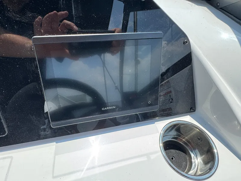 Slide: The Image of Garmin display on 2025 Stingray 201 DC boat dashboard with cup holder. - 7