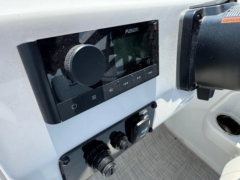 Slide: The Image of Control panel of 2025 Stingray 201 DC boat featuring Fusion audio system. - 8