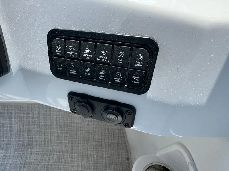 Slide: The Image of Control panel of 2025 Stingray 201 DC boat with various switches and USB ports. - 9