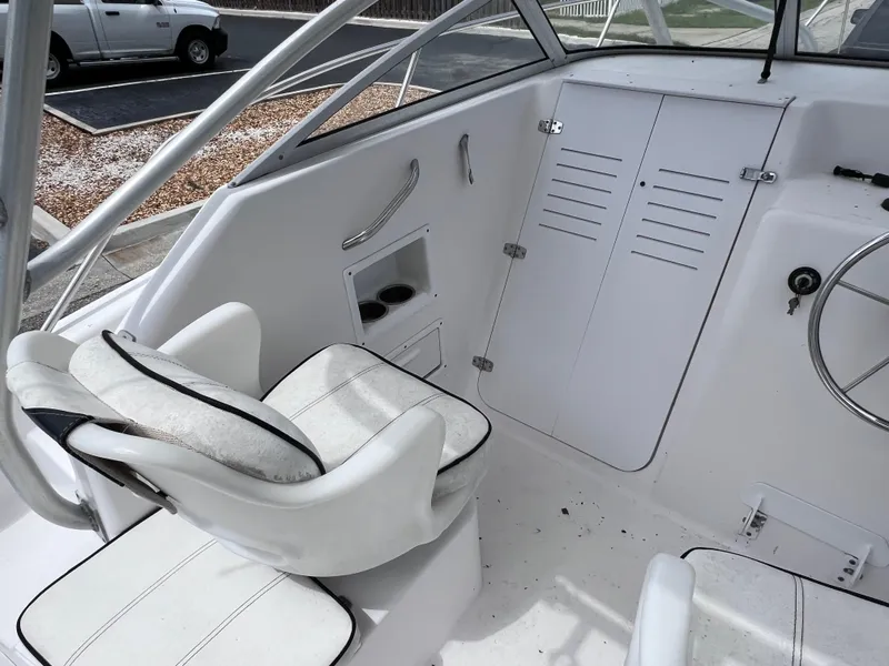 Slide: The Image of 2000 Pro-Line 20 Walk Around boat interior with seating and steering wheel. - 13