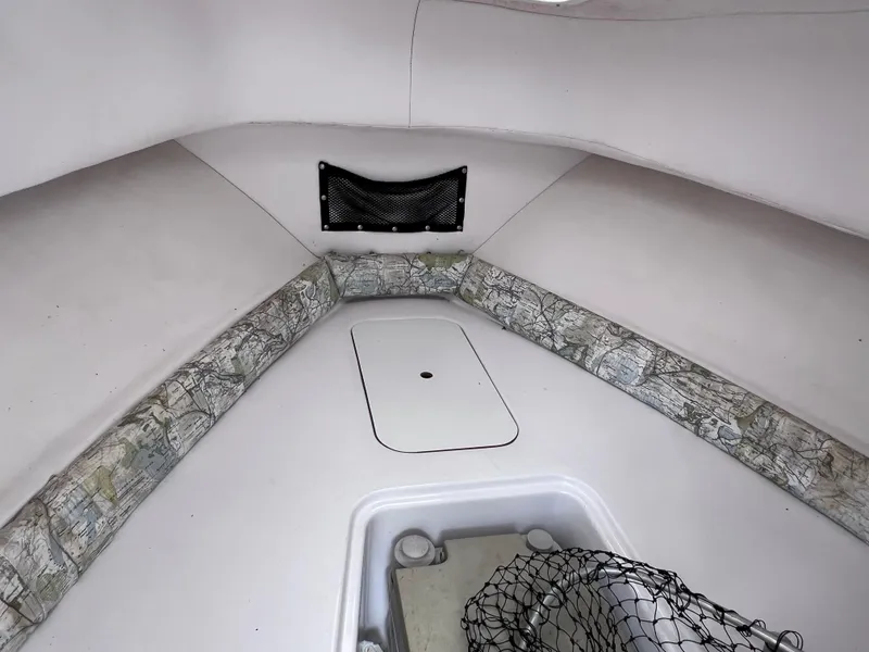 Slide: The Image of 2000 Pro-Line 20 WALK AROUND cabin interior with storage and netting. - 20