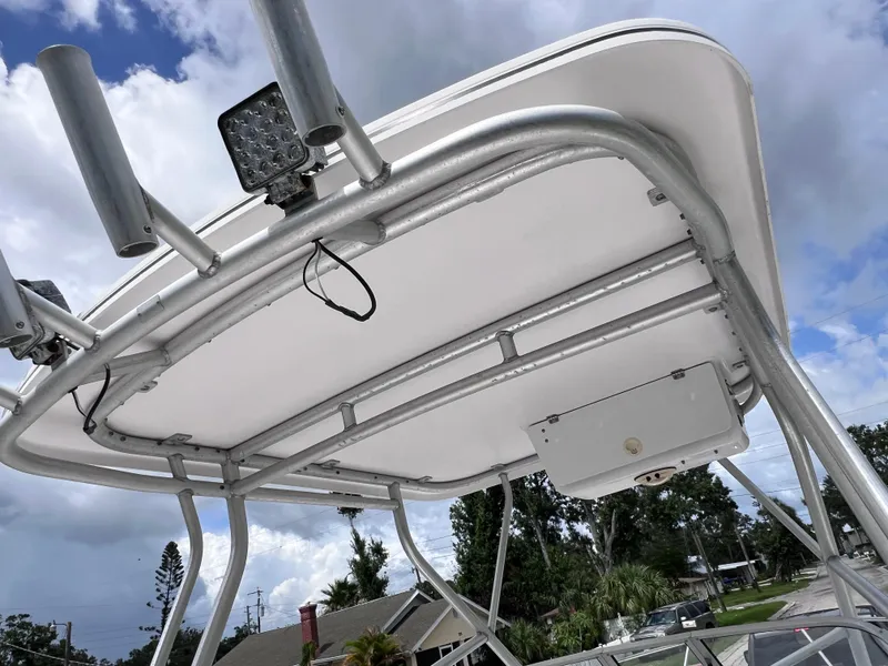 Slide: The Image of T-top of 2000 Pro-Line 20 WALK AROUND boat with rod holders and lights. - 21