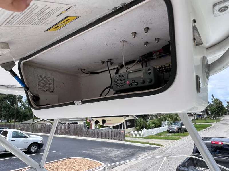 Slide: The Image of Open storage compartment on 2000 Pro-Line 20 WALK AROUND boat, showing electronic equipment. - 23