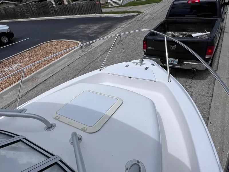 Slide: The Image of 2000 Pro-Line 20 WALK AROUND boat on trailer, parked behind a black truck. - 24