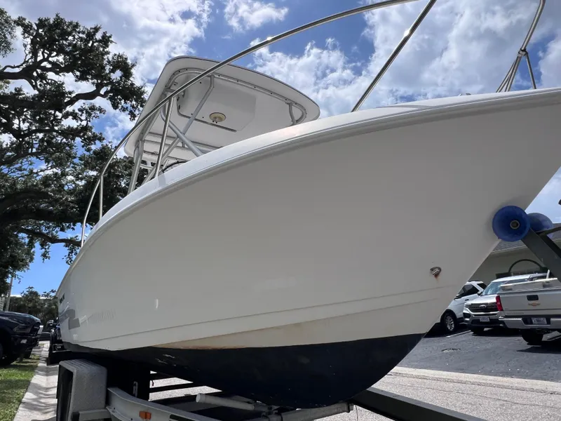 Slide: The Image of 2000 Pro-Line 20 Walk Around boat on trailer under a partly cloudy sky. - 4