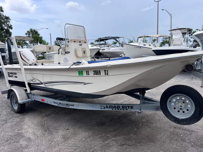 Slide: The Image of 2017 Carolina Skiff 18 JVX CC boat on trailer, parked in marina lot. - 4
