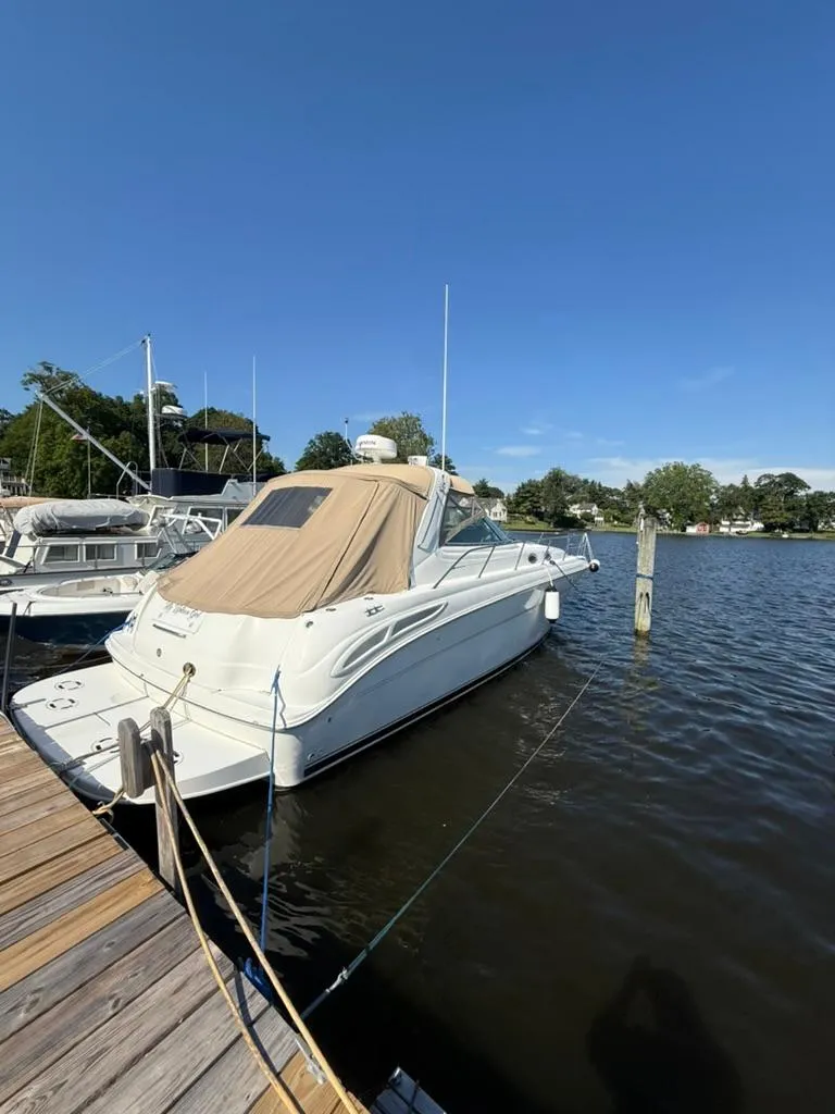 The Image of 2000 Sea Ray 380 Sundancer docked at a marina under clear blue skies. - 1
