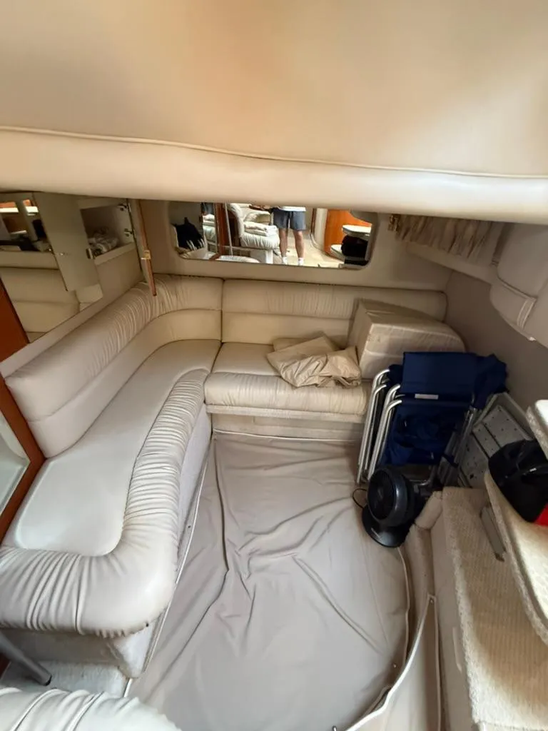 Slide: The Image of Interior of 2000 Sea Ray 380 Sundancer with cream leather seating and compact design. - 11
