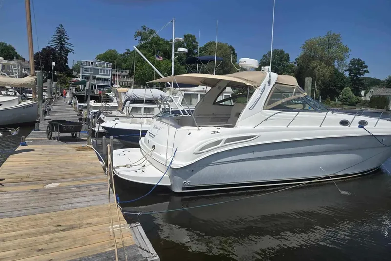 Slide: The Image of 2000 Sea Ray 380 Sundancer docked at a marina on a sunny day. - 16