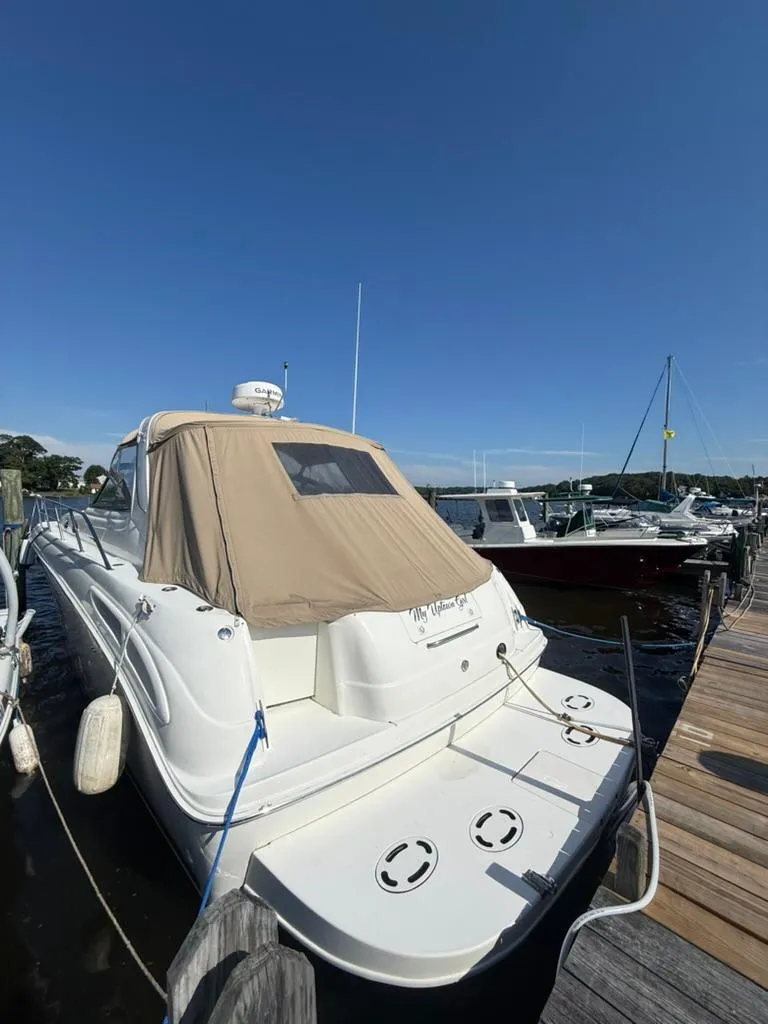 Slide: The Image of 2000 Sea Ray 380 Sundancer docked at marina under clear blue sky. - 3
