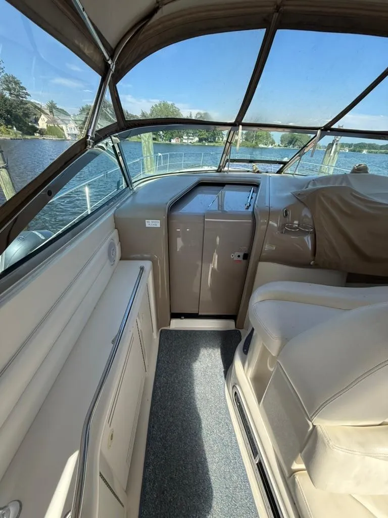 Slide: The Image of Interior view of a 2000 Sea Ray 380 Sundancer boat cockpit with beige seating. - 5
