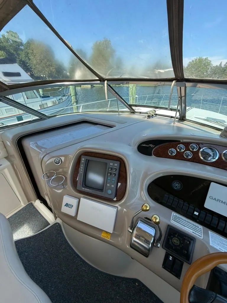 Slide: The Image of Helm of 2000 Sea Ray 380 Sundancer with navigation equipment and controls. - 7