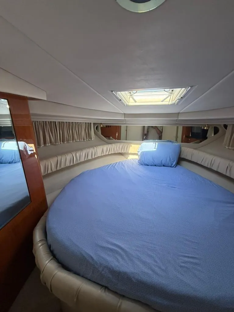 Slide: The Image of Cozy cabin interior of 2000 Sea Ray 380 Sundancer with round bed and skylight. - 8