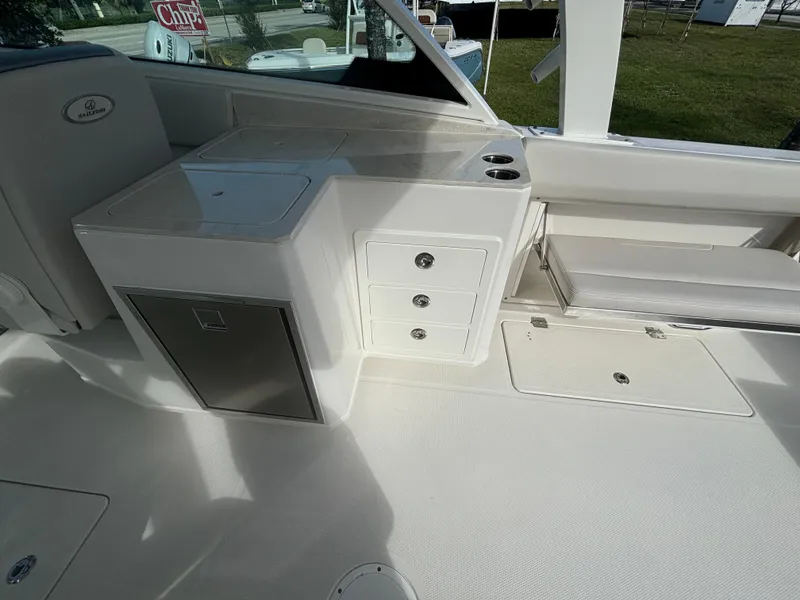 Slide: The Image of Sailfish 316 DC 2025 boat interior with white seating and stainless steel hardware. - 11