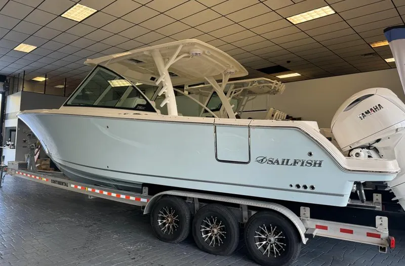 Slide: The Image of 2025 Sailfish 316 DC boat on trailer in showroom. - 3