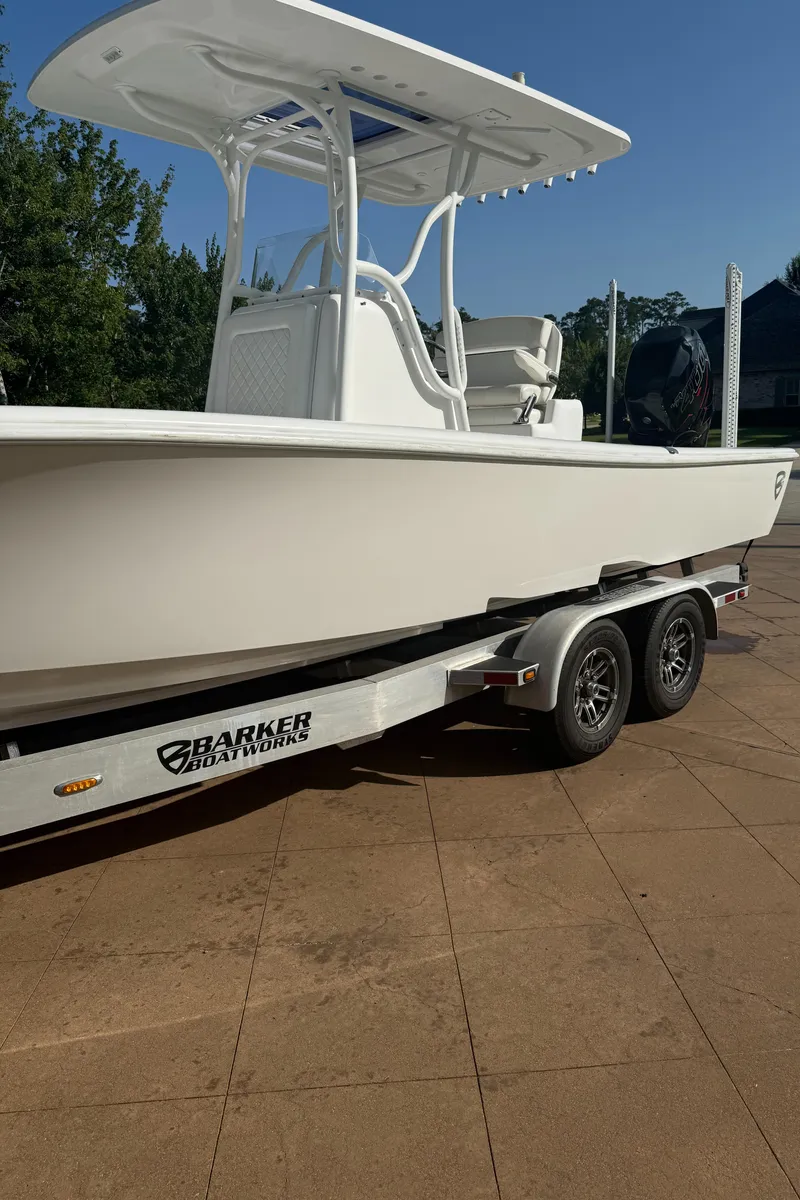 Slide: The Image of 2016 Barker Boatworks Calibouge on trailer, white hull, dual-axle, sunny day. - 11