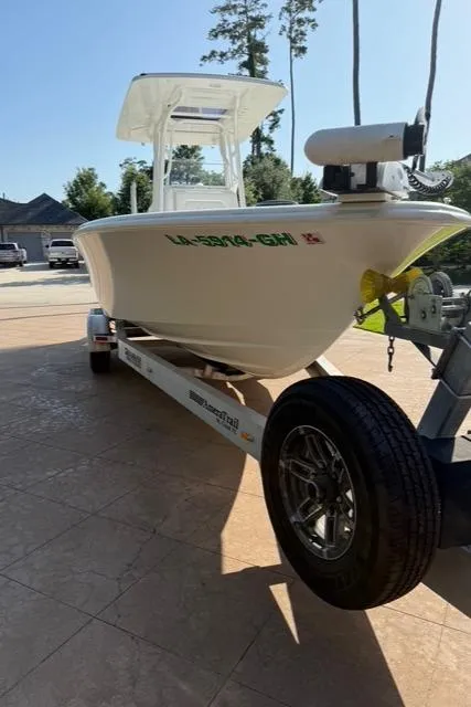 Slide: The Image of 2016 Barker Boatworks Calibouge on trailer, parked outdoors, with trees in the background. - 19