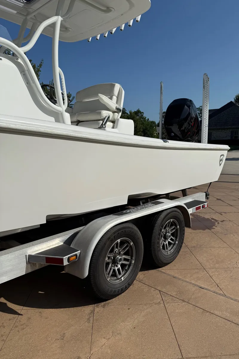 Slide: The Image of 2016 Barker Boatworks Calibouge on trailer, white exterior, outdoor setting. - 20