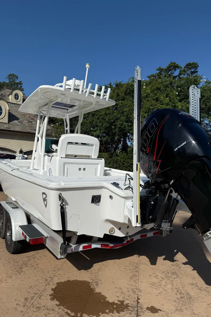 Slide: The Image of 2016 Barker Boatworks Calibouge on trailer with powerful outboard motor, parked outdoors. - 22