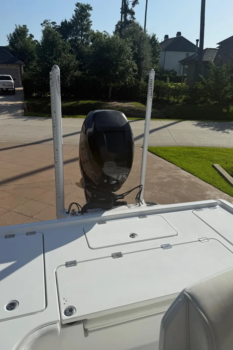 Slide: The Image of 2016 Barker Boatworks Calibouge with outboard motor, parked in a driveway. - 3