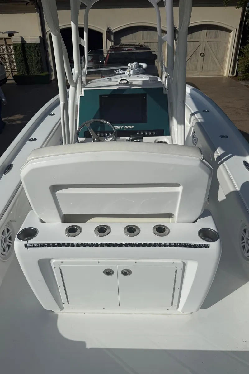 Slide: The Image of 2016 Barker Boatworks Calibouge center console with rod holders and storage compartments. - 4