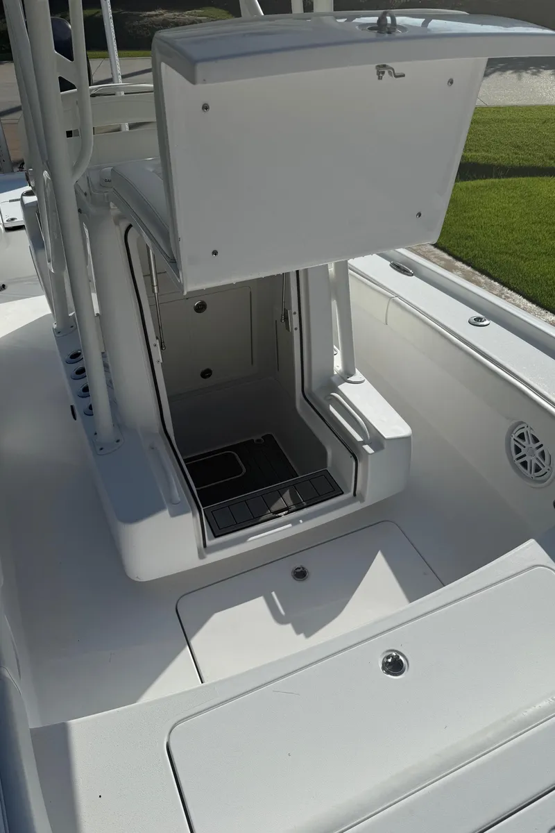 Slide: The Image of 2016 Barker Boatworks Calibouge interior with open storage compartment and seating. - 6