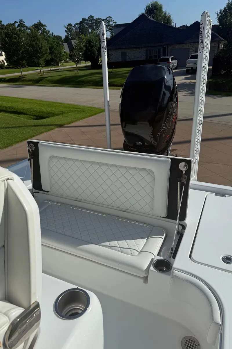 Slide: The Image of 2016 Barker Boatworks Calibouge with cushioned seating and outboard motor in a residential driveway. - 9