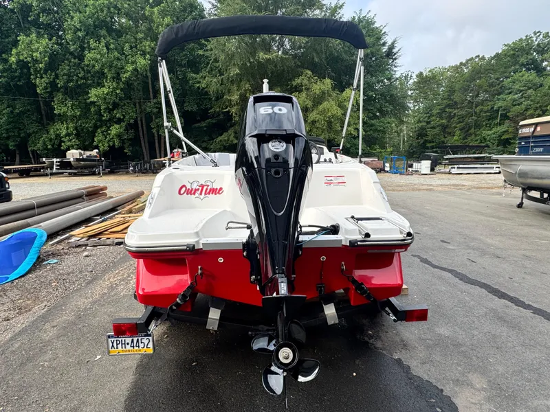 Slide: The Image of 2024 Bayliner Element M15 boat with outboard motor, parked outdoors. - 4