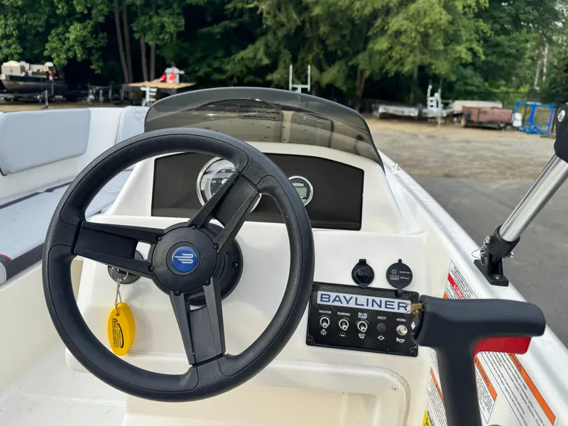 Slide: The Image of 2024 Bayliner Element M15 steering console with controls and dashboard. - 5