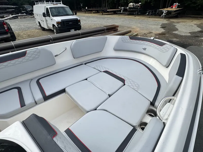 Slide: The Image of 2024 Bayliner Element M15 boat interior with gray cushioned seating and cup holders. - 6