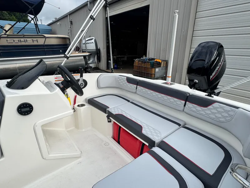 Slide: The Image of 2024 Bayliner Element M15 interior with seating and Mercury outboard motor. - 9