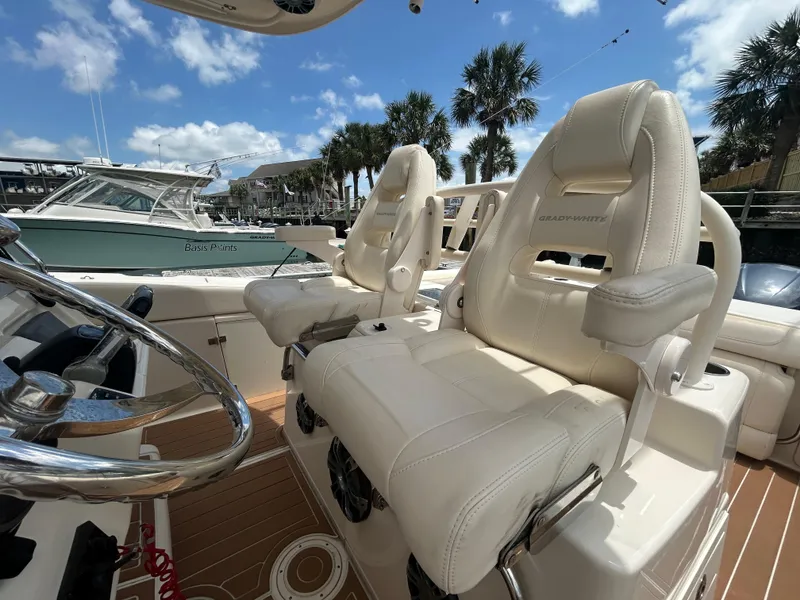 Slide: The Image of 2019 Grady-White Canyon 306 boat interior with luxurious seating and steering wheel. - 13