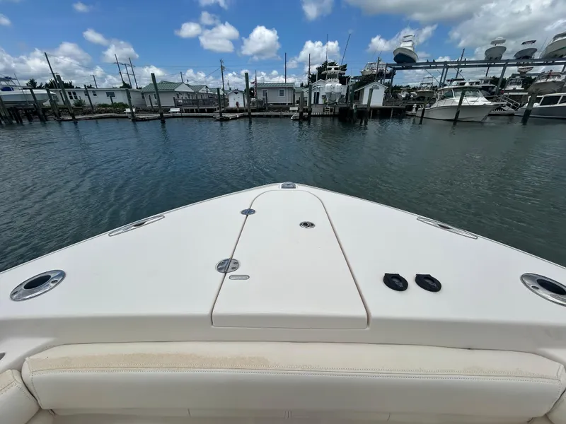 Slide: The Image of Bow view of 2019 Grady-White Canyon 306 boat in a marina setting. - 25