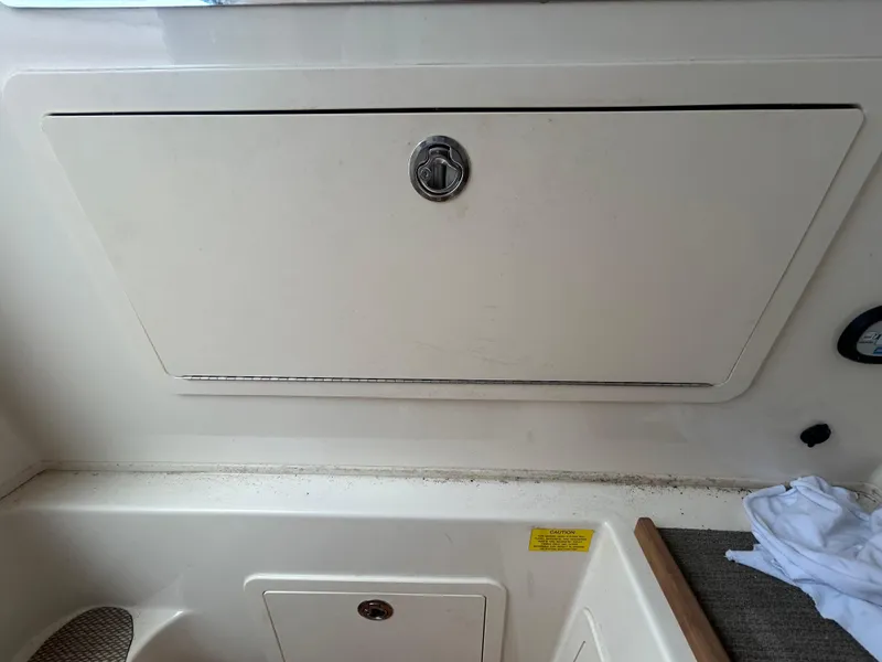 Slide: The Image of 2019 Grady-White Canyon 306 storage compartment with latch, interior view. - 29