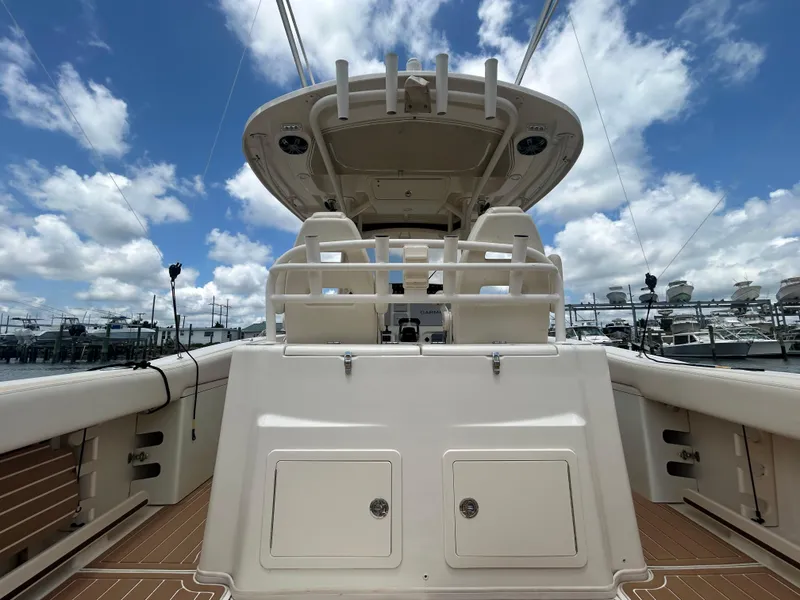 Slide: The Image of 2019 Grady-White Canyon 306 boat interior with helm, under a blue sky. - 3